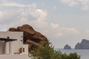 Sicily - Sunny impressions of the Aeolian Islands, also known as Aeolian Islands or Isole Eolie: Lipari, Stromboli, Salina, Vulcano, Panarea, Filicudi and Alicudi. White house built in a rock face, Panarea. Sicily - Sunny impressions of the Aeolian Islands, also known as Aeolian Islands or Isole Eolie: Lipari, Stromboli, Salina, Vulcano, Panarea, Filicudi and Alicudi. White house built in a rock face, Panarea.